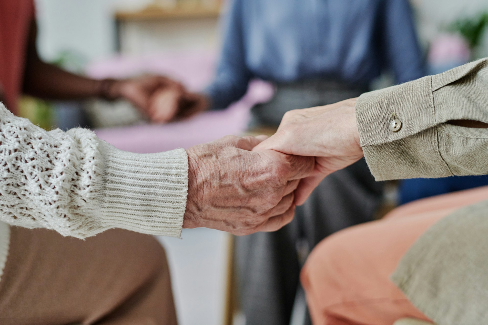 Caregiver supporting senior people at therapy