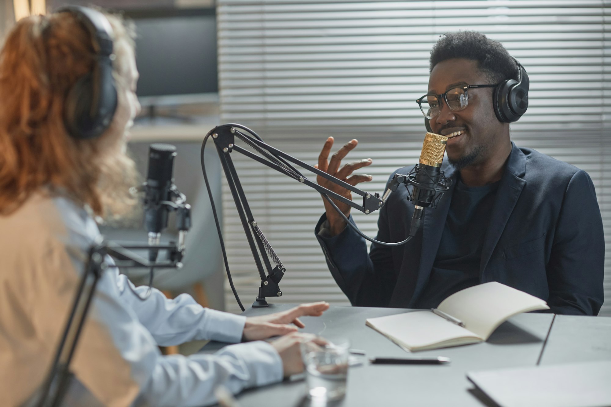 Cheerful Man in Headphones Speaking at Podcast